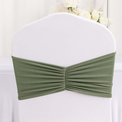 Olive green chair cover with ruched design for event decoration.