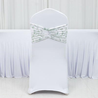 White chair cover with green decorative bow, studio shot.