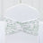 Floral patterned chair cover with ruched design on a plain backdrop