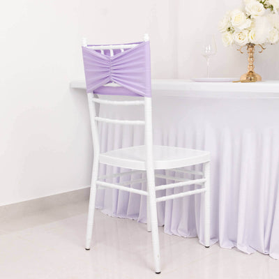 White chiavari chair with lavender satin cover against a plain backdrop.