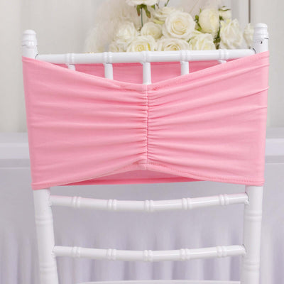 Pink chair cover with ruched design, perfect for event decor.