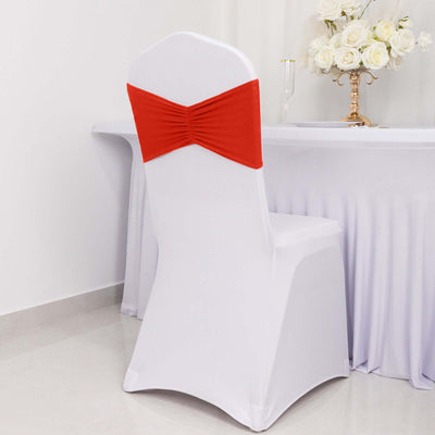 White chair cover with red bow, perfect for events or weddings.