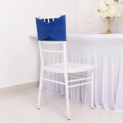 White chair with blue chair cover against a plain backdrop.