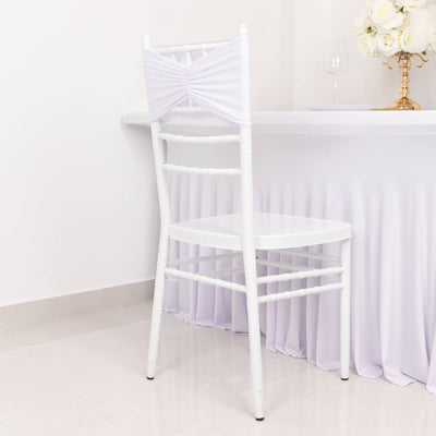 White chiavari chair with draped fabric detail against a plain backdrop.