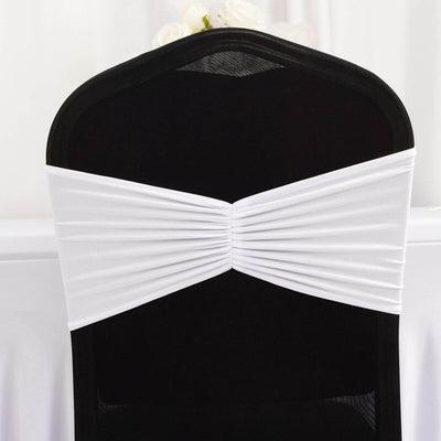 White chair cover sash tied on a black chair for event decoration.