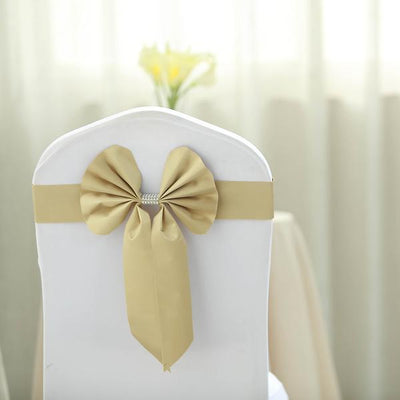 Gold satin chair cover bow for elegant event decor.
