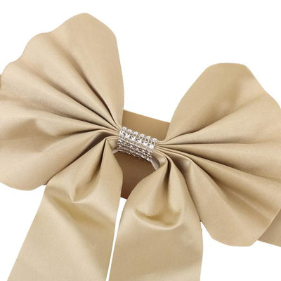 Elegant gold satin bow with rhinestone embellishment