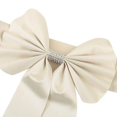 Elegant ivory satin bow with rhinestone embellishment.