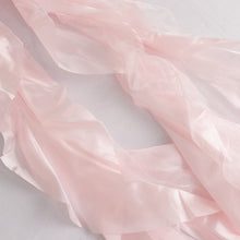 a close up of satin & taffeta chair sashes in pink#whtbkgd