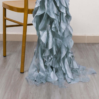 Light blue ruffled fabric draped on a chair leg.
