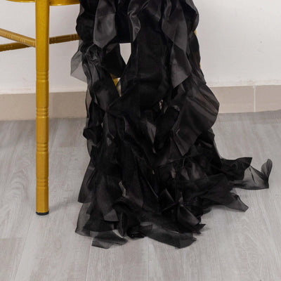Black ruffled fabric draped on a chair leg.