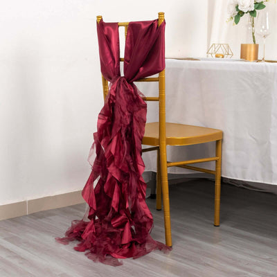 Burgundy chair sash draped elegantly on a gold chair at a dining table.