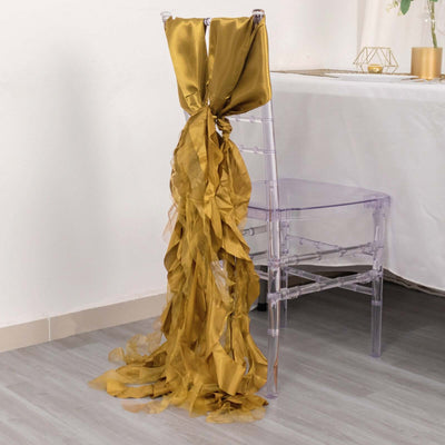 Gold satin chair sash draping elegantly over a clear acrylic chair.