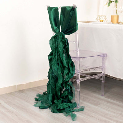 Green satin chair sash draping elegantly on a clear acrylic chair.