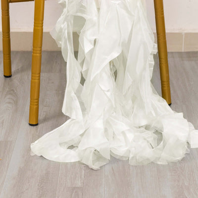 White ruffled fabric draped on a chair leg.