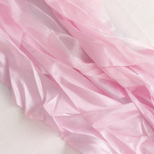 A close up of stylish satin & taffeta chair sashes in pink color on a white surface#whtbkgd