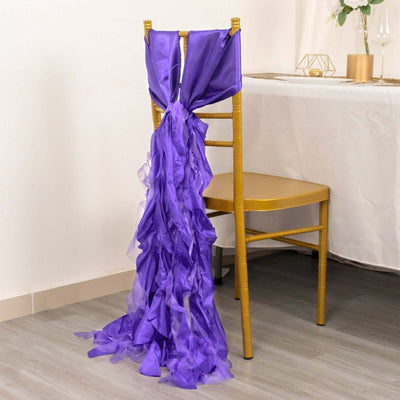 Purple ruffled chair sash draped over a gold chair.