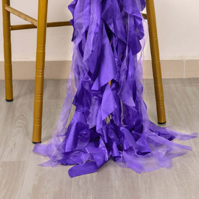Purple chiffon fabric draped elegantly from a chair leg.