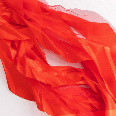 Red sheer fabric draped elegantly in flowing layers