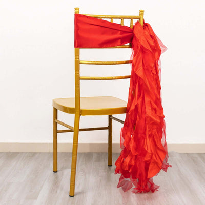 Gold chair with a red sash draped over the back