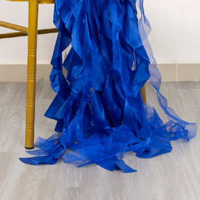Blue ruffled fabric draping from a chair leg.