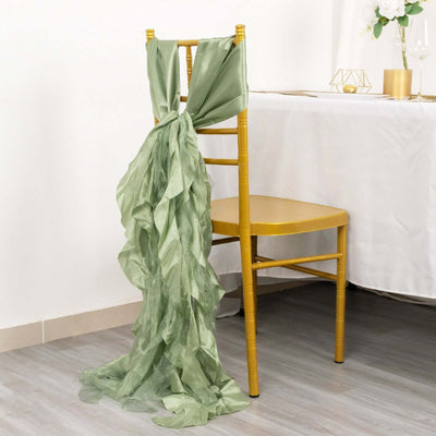Green chiffon chair sash draped elegantly on a gold chiavari chair.