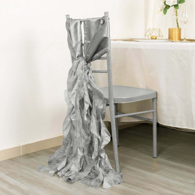 Silver satin chair sash with ruffled design draped over a chair.
