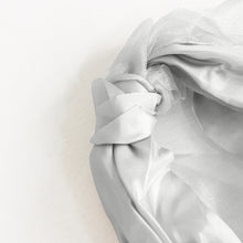 Satin & taffeta chair sashes - a white headband with a knot in the middle#whtbkgd