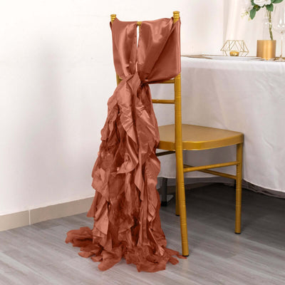 Satin chair sash in rust color draped elegantly on a gold chair.