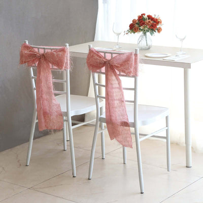 Chairs with pink mesh bows in a bright dining setting.