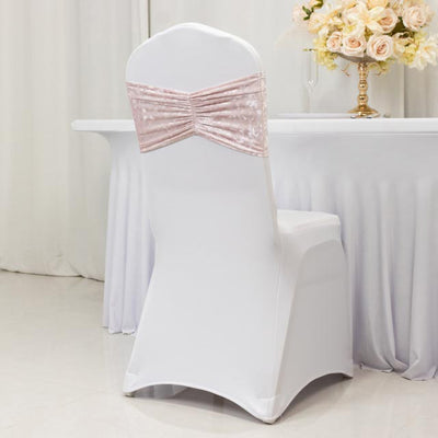 White chair cover with pink satin bow, ideal for event decor.