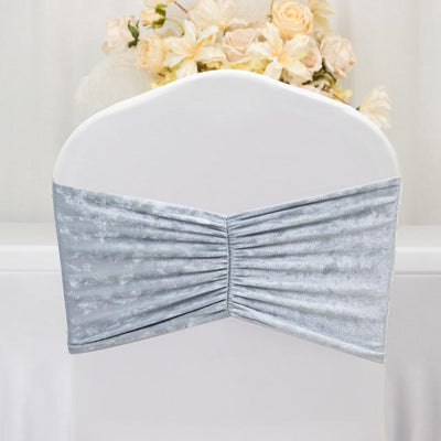 Silver chair cover with ruched design for elegant event decor.