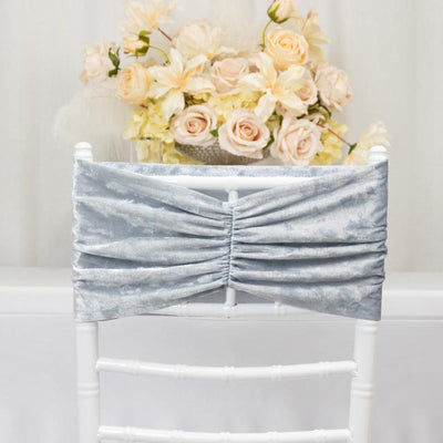Silver velvet chair sash with gathered design, styled on a white chair.