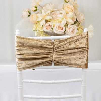 Gold chair sash draped over a white chiavari chair with floral backdrop.