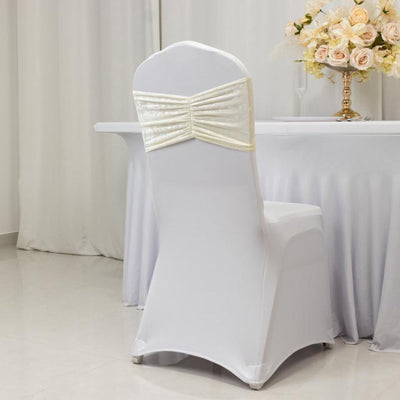 White chair cover with elegant bow detail, perfect for events.