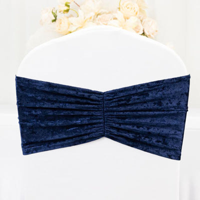 Navy blue velvet chair cover with pleated design.