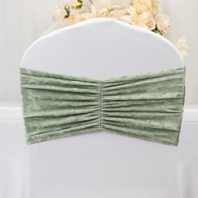 Green velvet chair cover with gathered design for elegant decor.