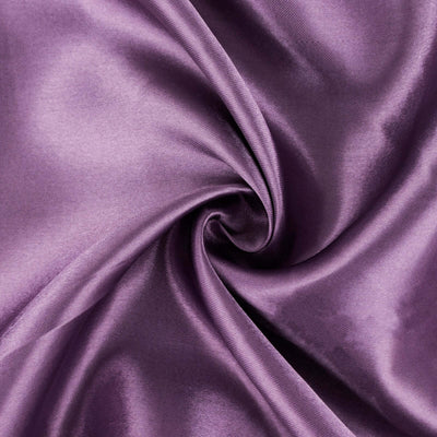 Purple satin fabric swirling in a circular pattern.