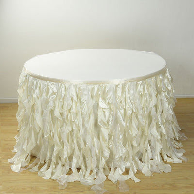White table with ruffled satin skirt for events and celebrations.