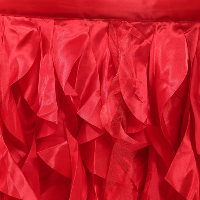 Red ruffled fabric with shiny texture and layered design.