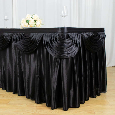 Black satin table skirt with pleated design, ideal for elegant events.