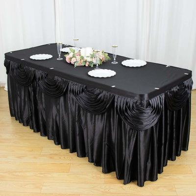 Black table skirt with pleated design, perfect for elegant events.