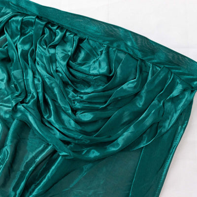 Teal satin fabric draped elegantly