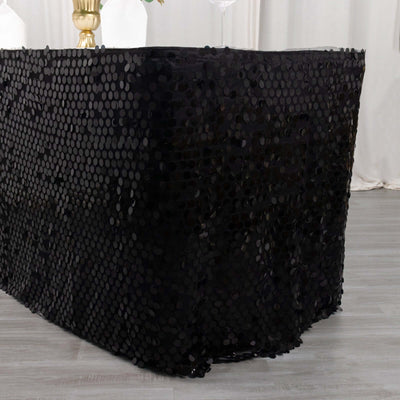 Black sequin tablecloth draped elegantly over a table edge.