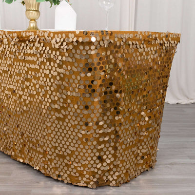 Gold sequin tablecloth draped over a table in a festive setting.