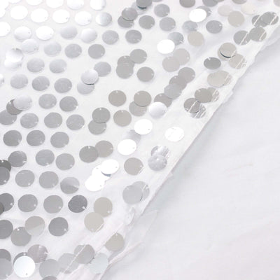 Silver sequin fabric with circular sequins on a white background.