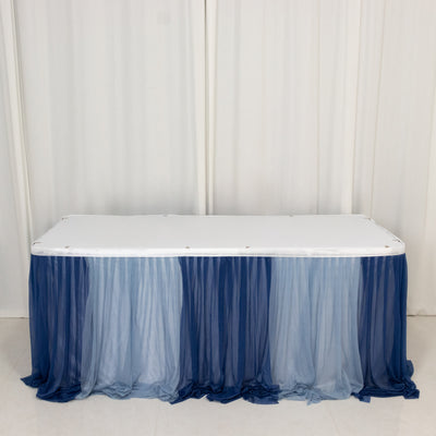 Table covered with blue ombre draping fabric.