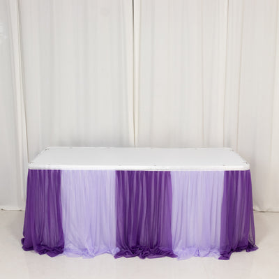 Purple and lavender table skirt draped over a white table.