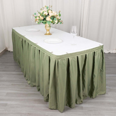 Elegant green tablecloth draped over a banquet table with floral centerpiece.