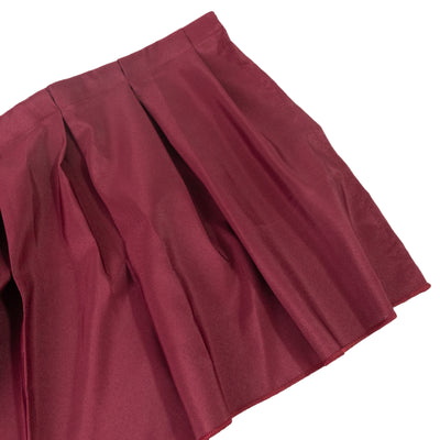 Burgundy pleated skirt on a white background